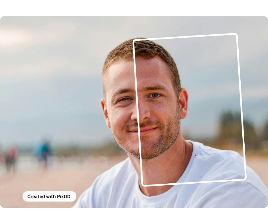 Man at a beach in white t-shirt with short brown hair