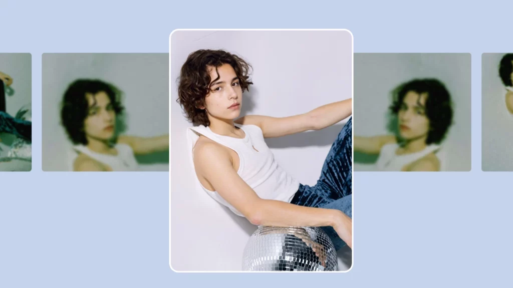 Clear focus image of a young boy in a white tank top leaning on a disco ball, with blurred versions in the background to emphasize AI image upscaling.